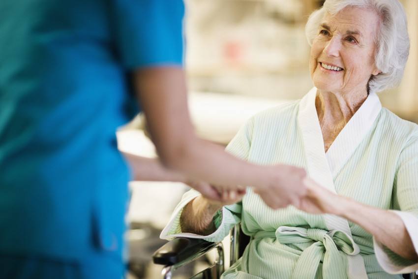 Nurse Holding Hands with Elderly Patient